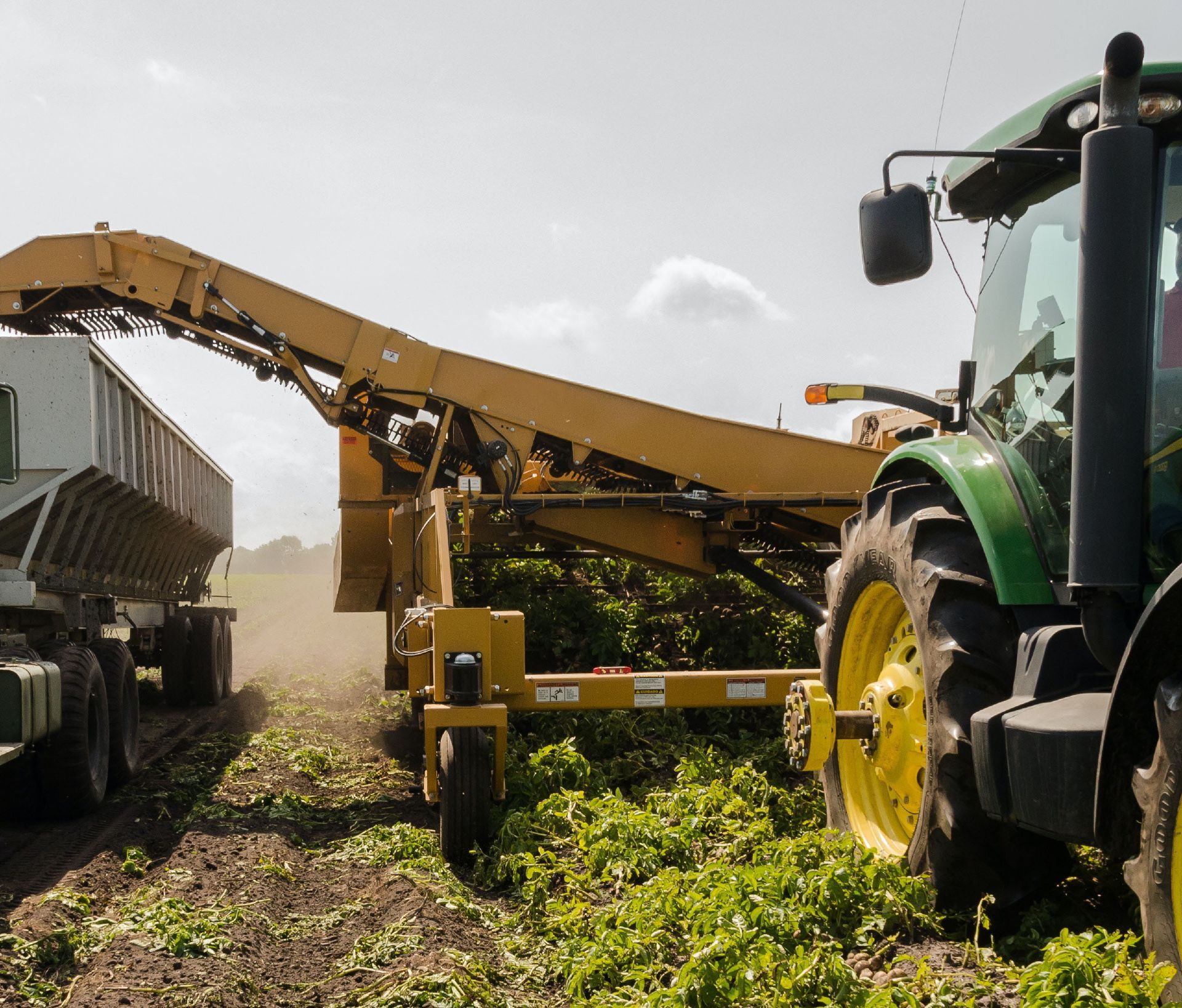Tractor and harvester in the field