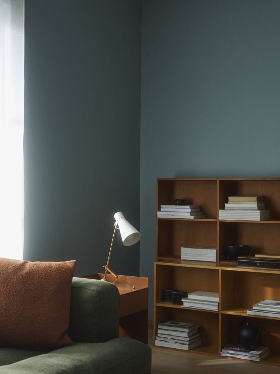 Furnish a cosy corner for diving into your favourite novel with a comfortable seating set against a calming blue wall, such as MUTE Ocealis, which is a soft, muted blue teal with a serene feel.