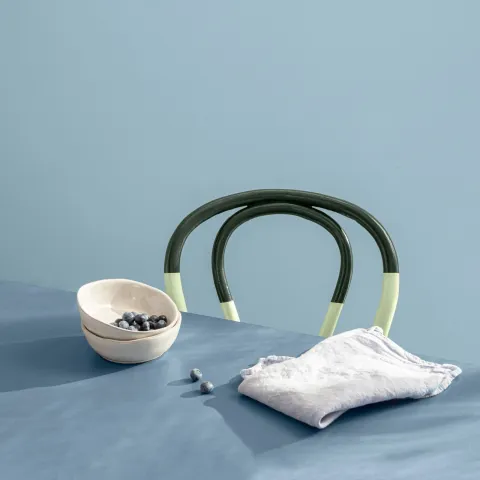 blue table top and chair painted with dark blue and green details